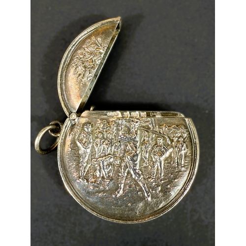 707 - An unusual circular hallmarked silver vesta case depicting a golfer in full swing, Birmingham 1906.