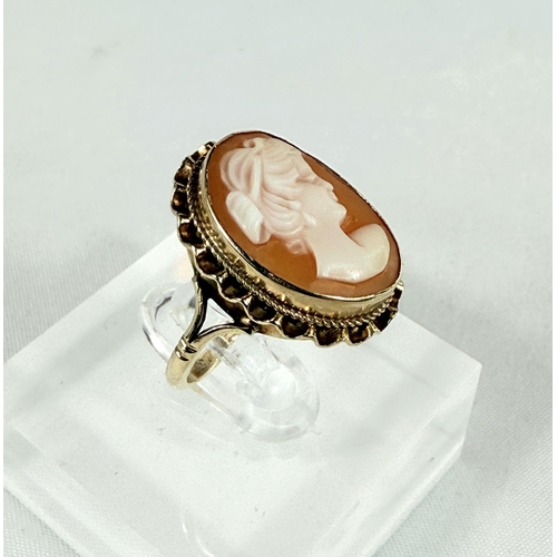 708 - A 9ct hallmarked gold ring set with a female head cameo, 3.5gms, size N.