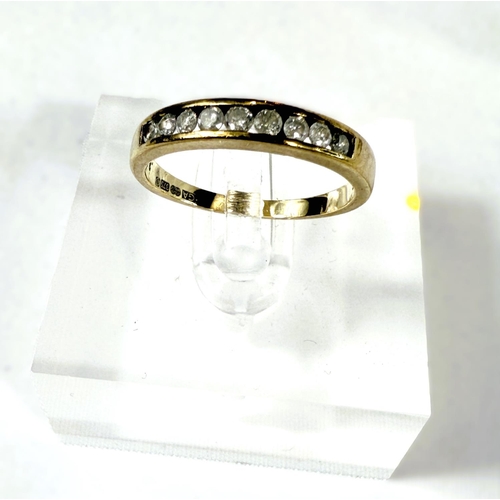 710 - A 9 carat hallmarked gold eternity ring, set with 9 diamonds, 2gms, size 'M'.