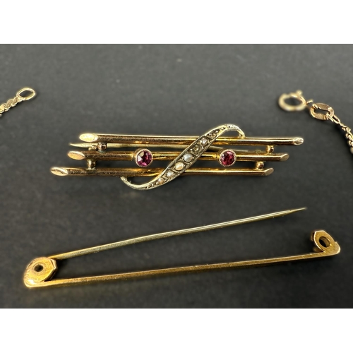 712 - A triple bar yellow metal brooch set with seed pearl link crossover (some pearls are missing); a  pl... 