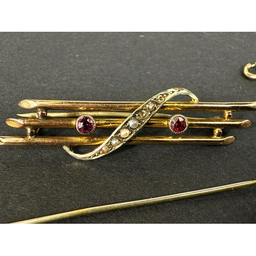 712 - A triple bar yellow metal brooch set with seed pearl link crossover (some pearls are missing); a  pl... 