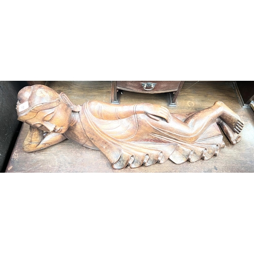 72 - A large carved figure of reclining Buddha, length 70cm.