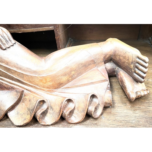 72 - A large carved figure of reclining Buddha, length 70cm.