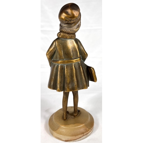 818 - An Art Deco gilt bronze figure of a young girl in coat holding a bag, with carved ivory face, on mot... 