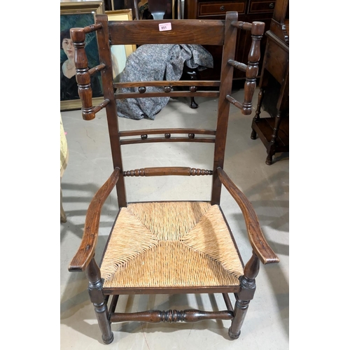 851 - A 19th century country made rush seat elm nursing chair with wool winders to the back.