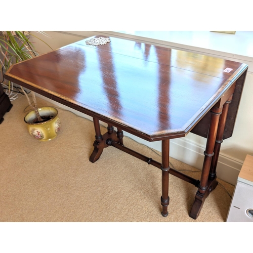 857 - A reproduction mahogany drop leaf Pembroke table, canted edges; a nest of three mahogany tables.