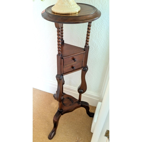 865 - A mahogany reproduction gentleman's shaving stand with tilt columns and drawers and a magazine rack.