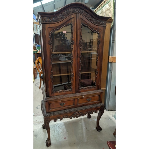 868 - A reproduction French Rococo-style display cabinet with double-glazed doors, drawers under and cabri... 