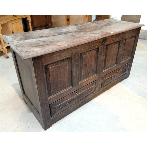 870 - An 18th Century oak mule chest with carved panel decoration, two drawers below and hinged lid.