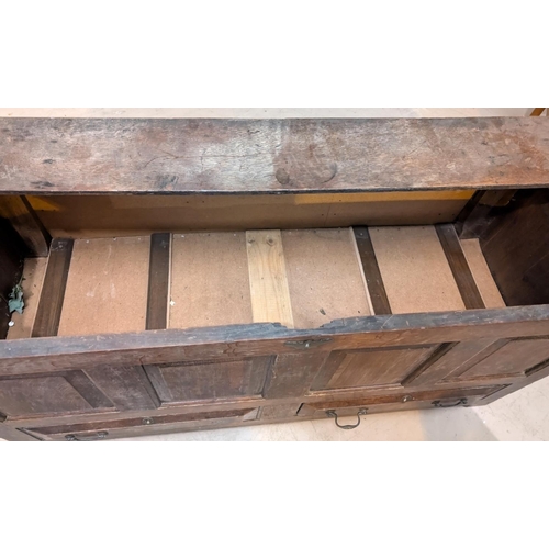 870 - An 18th Century oak mule chest with carved panel decoration, two drawers below and hinged lid.