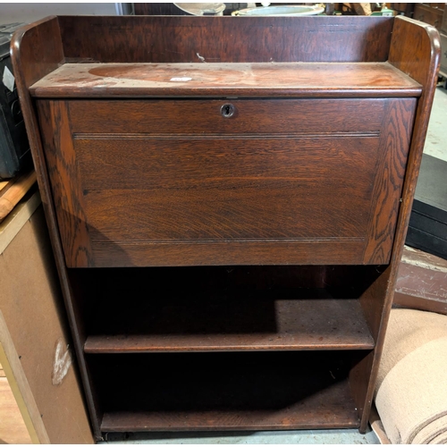 871 - An oak fall-front unit with writing surface and bookshelves below.