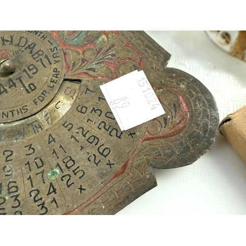 89 - A Perpetual Calendar in enamelled brass, a 19th century ambrotype portrait and various collectables