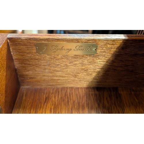 895 - A reproduction mahogany bookcase with drawers above.