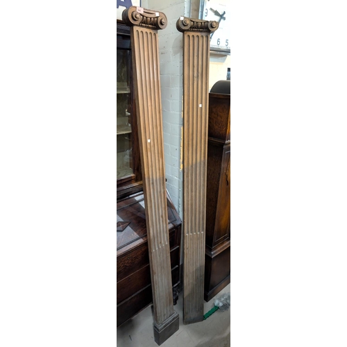 896 - A pair of late 19th century oak classical style pilasters with scroll surmounts, (a/f), 200cm.