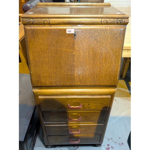 898 - A 1930's oak Joseph Serlin fall front bureau of tall narrow proportions with composition handles.