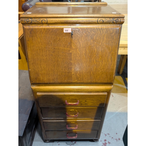 898 - A 1930's oak Joseph Serlin fall front bureau of tall narrow proportions with composition handles.