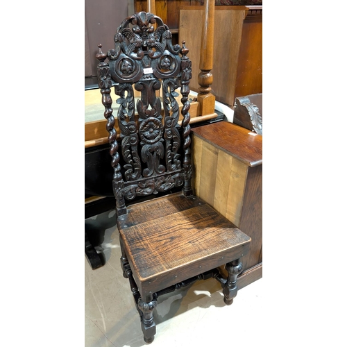 904 - A 19th century oak Carolean style chair with elaborately carved high back, bulbous legs.