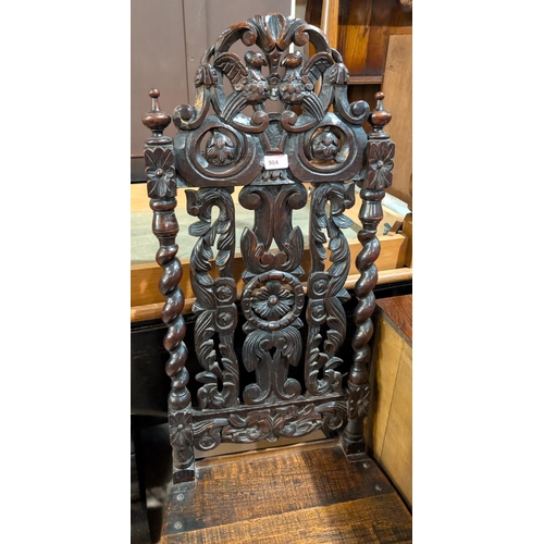 904 - A 19th century oak Carolean style chair with elaborately carved high back, bulbous legs.