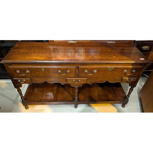 911 - An oak Titchmarsh and Goodwin traditional dresser base with two long and one single drawer with shel... 