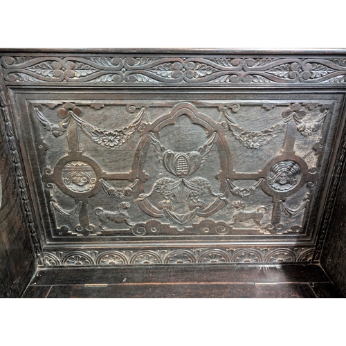 913 - A 19th century oak carved Jacobean style bench with box seat and carved Royal King and Queen to upri... 