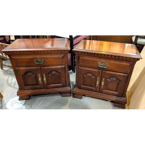 914 - A pair of mahogany reproduction bedside cabinets with single drawer and two door below.