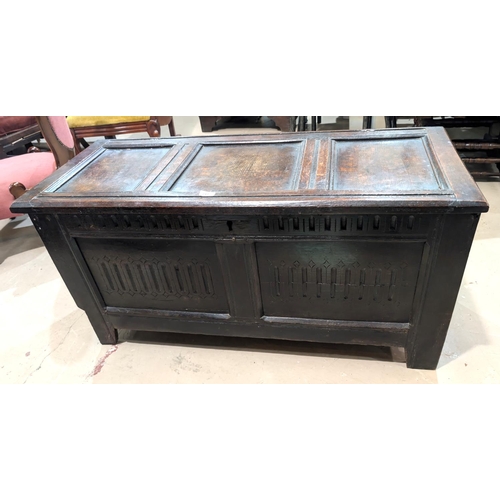 917 - An 18th century oak chest with panelled decoration.