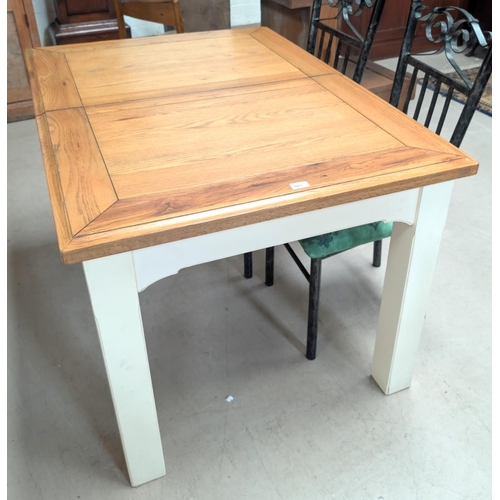 923 - A modern oak top extending dining table with painted base and four metal dining chairs.