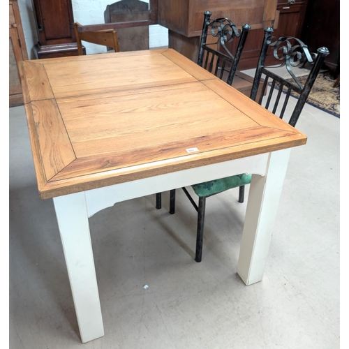 923 - A modern oak top extending dining table with painted base and four metal dining chairs.