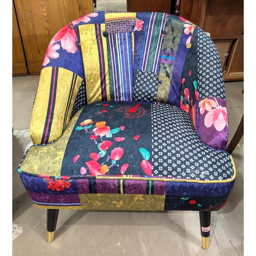 926 - A modern tub chair upholstered in bright multi-patterned and coloured fabric.