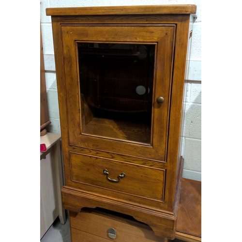 929 - A light wood single door cabinet with bevelled glazed panel and single drawer below. Height 98cm, wi... 