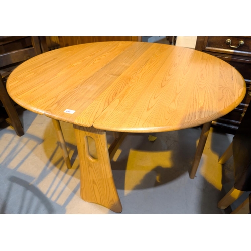 939 - An Ercol pale elm 'Windsor' drop leaf dining table, width 107cm, extended length approximately 120cm... 