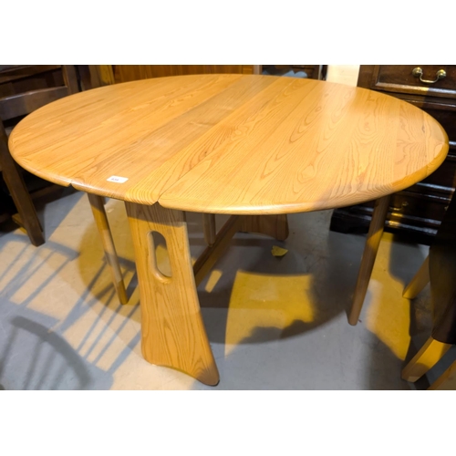 939 - An Ercol pale elm 'Windsor' drop leaf dining table, width 107cm, extended length approximately 120cm... 