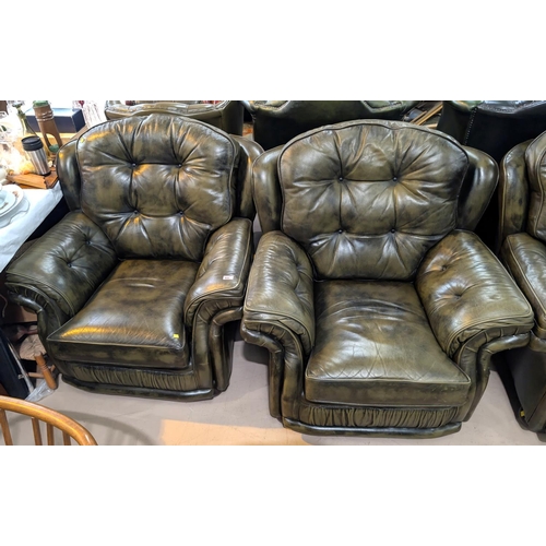 944 - An antique green pair of chesterfield armchairs with button backs 