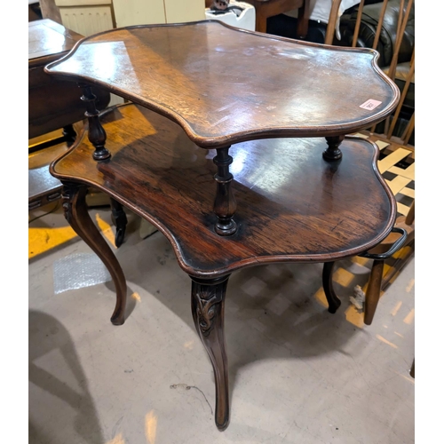 957 - An unusual rosewood two tier dumb waiter style occasional table, with turned supports