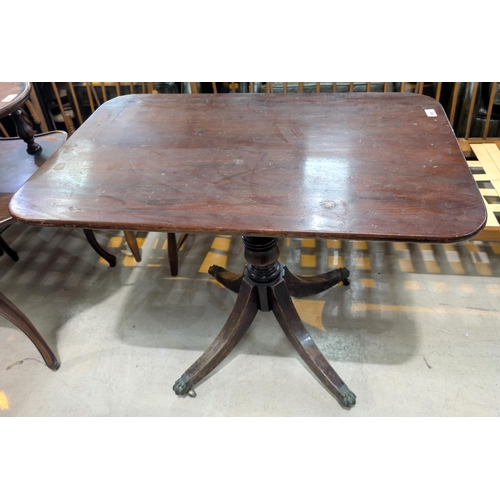 958 - A Georgian mahogany rectangular tilt top table with turned column and four splay feet