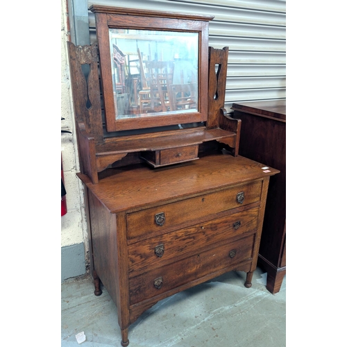 962 - An oak Arts and Crafts dressing chest with mirror back and three drawers bellow