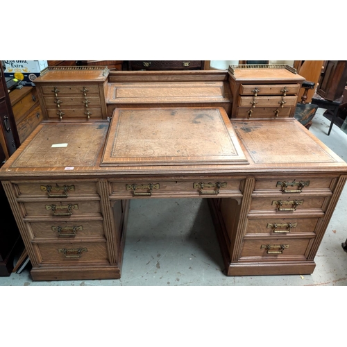 963 - Galloway and Sykes Aberdeen:- an Arts and Crafts oak kneehole desk with 2 raised 3 height galleried ... 