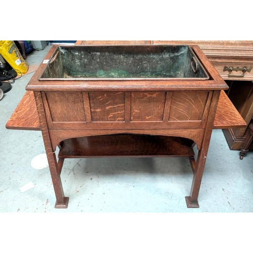 964 - Goodall, Lamb and Heighway Manchester, a large Arts and Crafts style oak planter with metal lines si... 