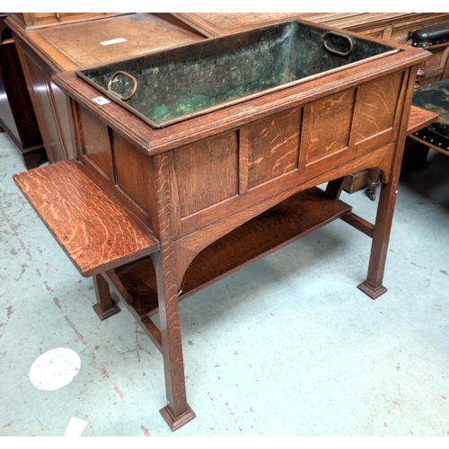 964 - Goodall, Lamb and Heighway Manchester, a large Arts and Crafts style oak planter with metal lines si... 