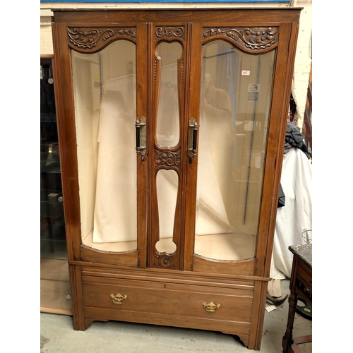 969 - An Edwardian walnut wardrobe converted to display cabinet and ended by two bevelled glass doors with... 