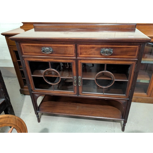 970 - A mahogany cabinet with glazed cupboard and two drawers above.