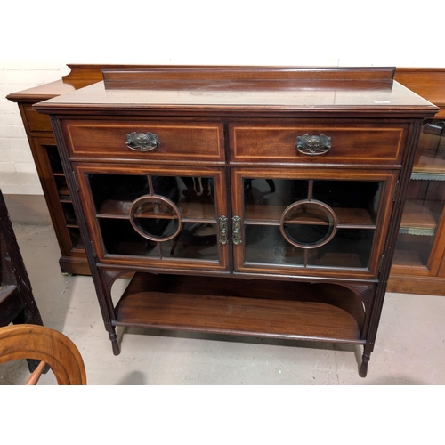 970 - A mahogany cabinet with glazed cupboard and two drawers above.