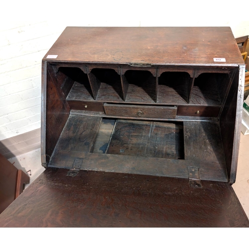 972 - A 19th oak century bureau with fall front, well beneath writing surface and drawers below