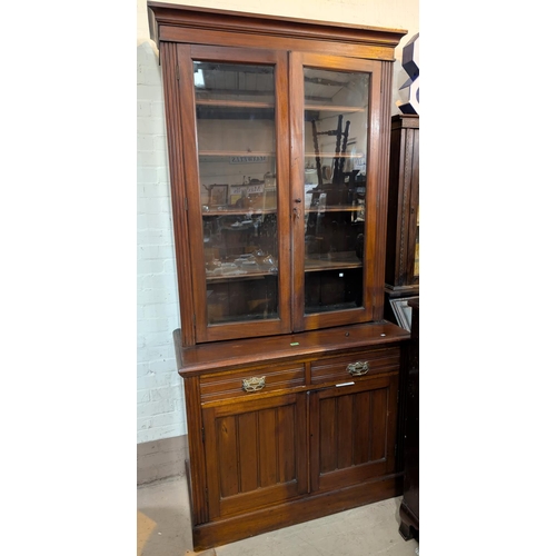 974 - An Edwardian mahogany full height bookcase with double glazed doors above and drawers and cupboards ... 