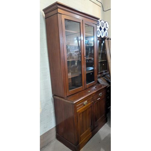 974 - An Edwardian mahogany full height bookcase with double glazed doors above and drawers and cupboards ... 