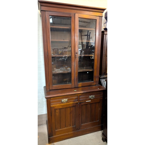 974 - An Edwardian mahogany full height bookcase with double glazed doors above and drawers and cupboards ... 