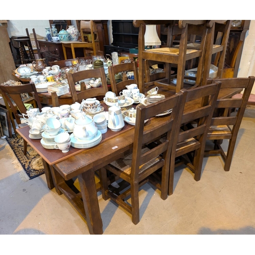 976 - A period style oak dining suite comprising large refectory table, length 220cm and 6 (4+2) ladder ba... 