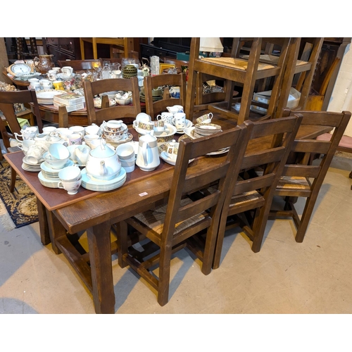 976 - A period style oak dining suite comprising large refectory table, length 220cm and 6 (4+2) ladder ba... 