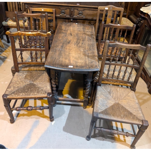 988 - A 1930's oak dining suite comprising drop leaf barley twist table, height 105cm, a heavy carved oak ... 