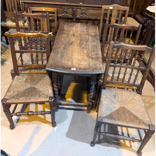 988 - A 1930's oak dining suite comprising drop leaf barley twist table, height 105cm, a heavy carved oak ... 